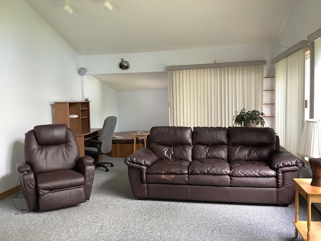 carpeted living room featuring vaulted ceiling