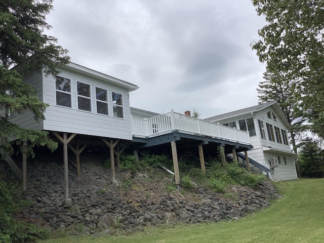 rear view of house with a deck and a sunroom