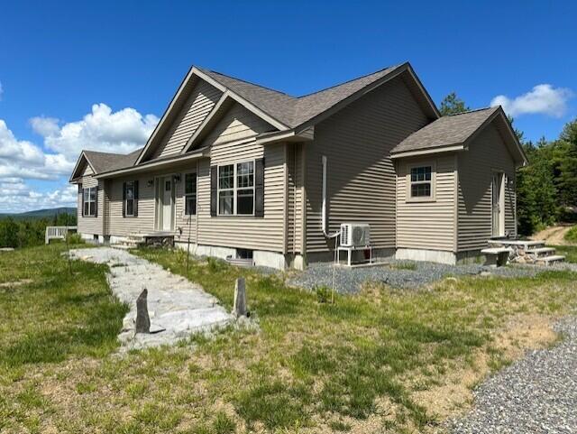 view of side of home featuring a yard