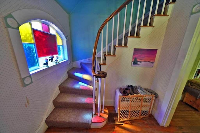 stairway with hardwood / wood-style flooring