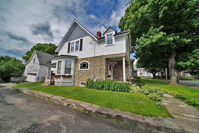 view of front of property with a front yard and a garage