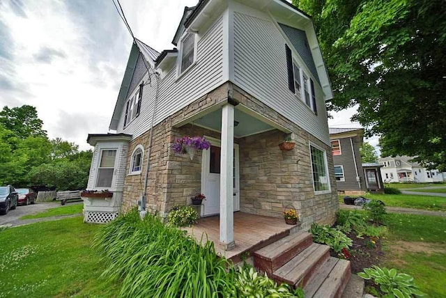 view of side of home featuring a lawn