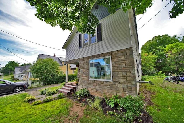 view of property exterior with a lawn