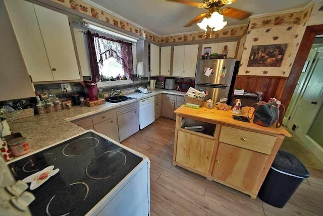 kitchen with white appliances, light hardwood / wood-style floors, ceiling fan, and sink