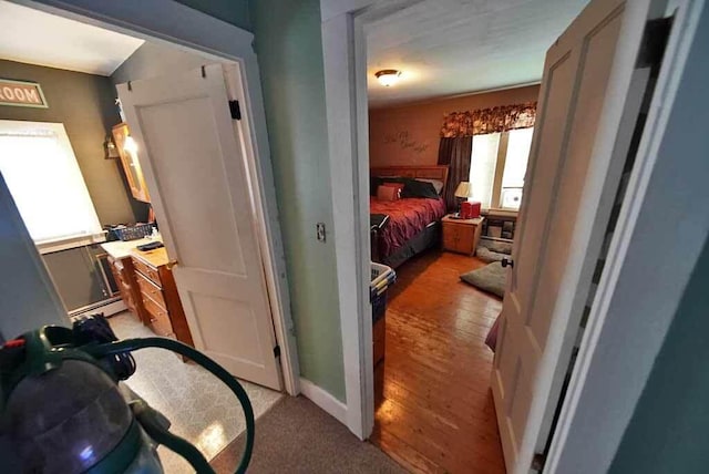 bedroom featuring a baseboard radiator and light wood-type flooring