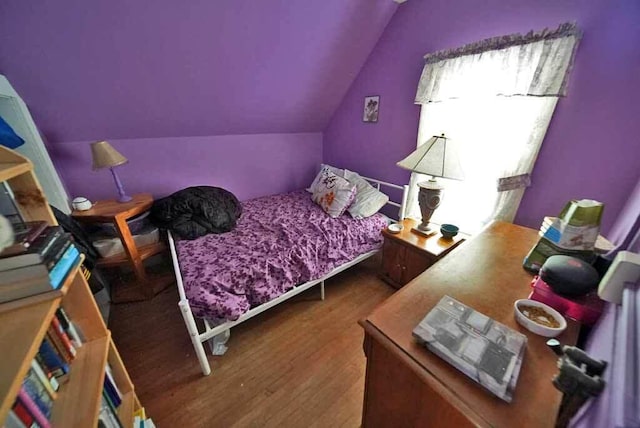 bedroom with hardwood / wood-style flooring and vaulted ceiling