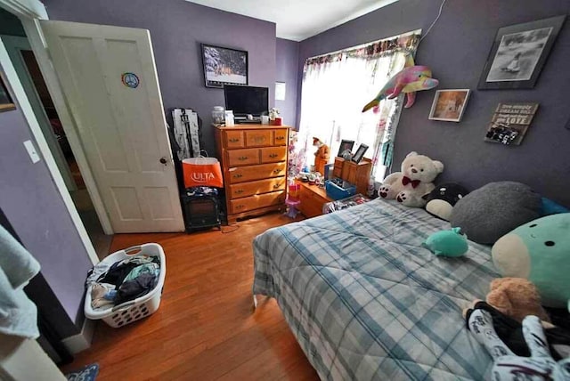 bedroom with hardwood / wood-style flooring