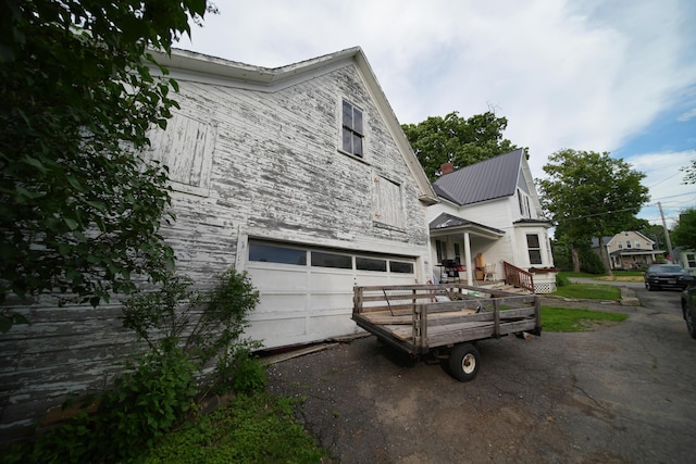 view of side of property with a garage