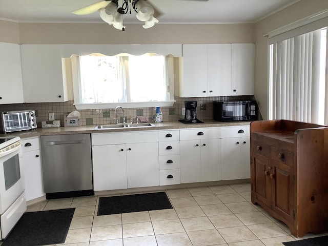 kitchen featuring backsplash, dishwasher, white cabinets, and sink