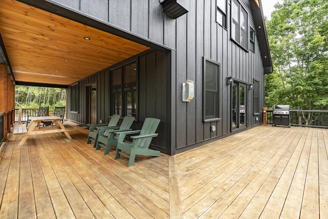 wooden deck featuring a grill