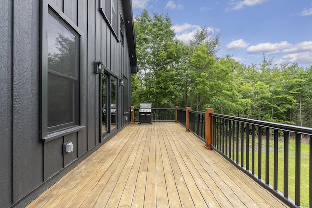 wooden terrace with a grill