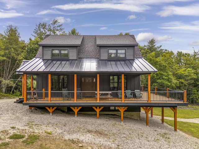 view of front of property with a standing seam roof, metal roof, board and batten siding, and roof with shingles