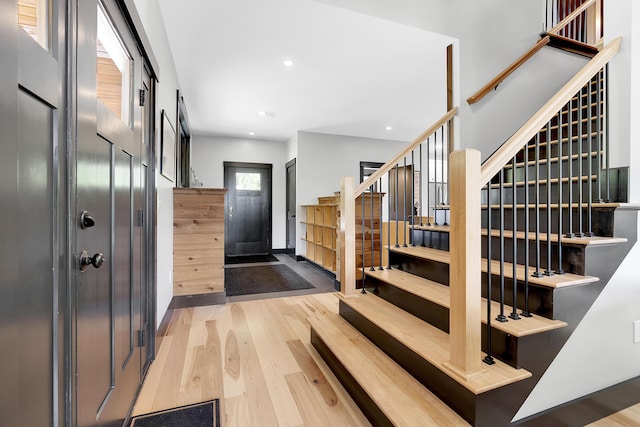 entrance foyer with stairs, recessed lighting, and wood finished floors