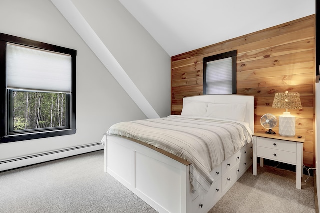 bedroom with lofted ceiling, wooden walls, a baseboard radiator, and light colored carpet