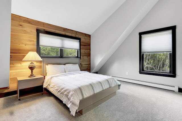 carpeted bedroom with a baseboard heating unit and lofted ceiling