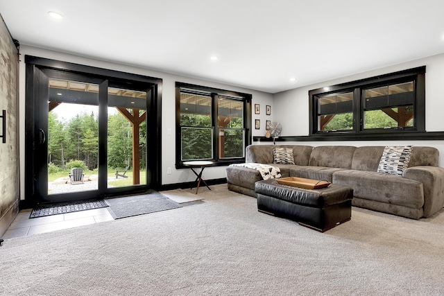 living room featuring carpet floors, recessed lighting, plenty of natural light, and tile patterned floors