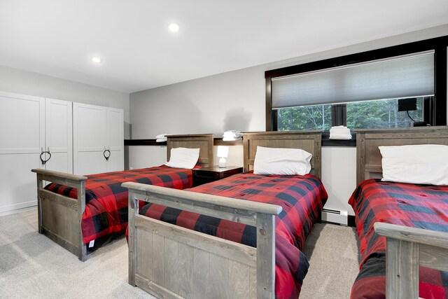 bedroom featuring recessed lighting, light colored carpet, and baseboard heating