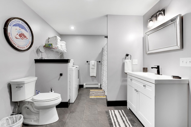 full bathroom featuring toilet, a baseboard heating unit, vanity, independent washer and dryer, and baseboards