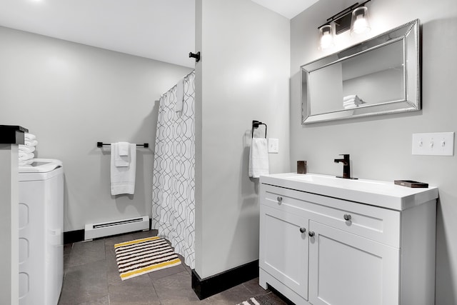 bathroom with washer and clothes dryer, curtained shower, baseboard heating, vanity, and baseboards