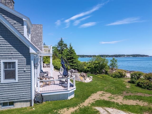 view of yard featuring a balcony and a deck with water view