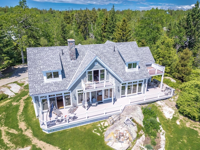 back of property with outdoor lounge area, a yard, a wooden deck, a balcony, and a patio