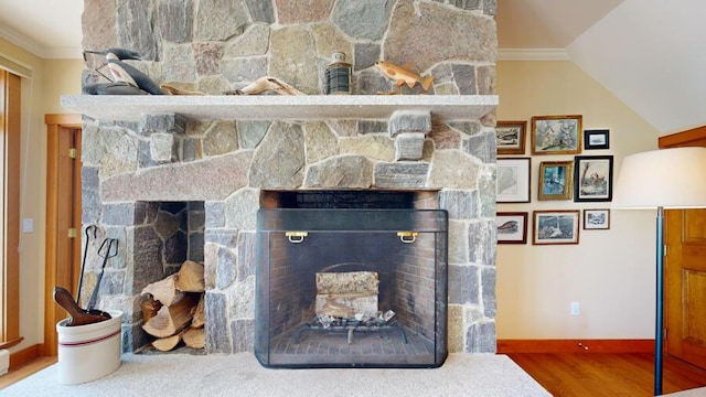 details featuring a stone fireplace, crown molding, and hardwood / wood-style floors