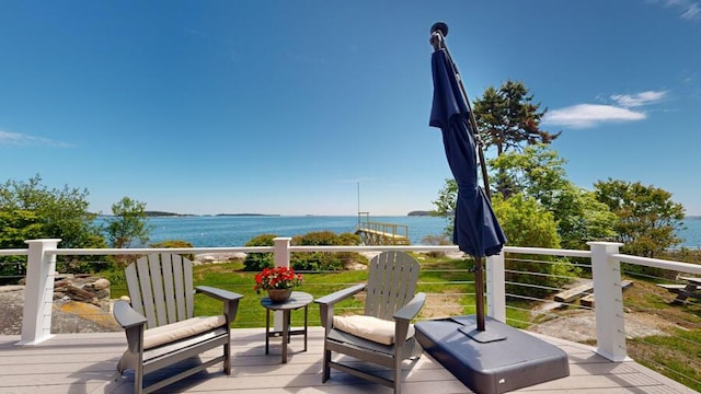 wooden deck featuring a water view