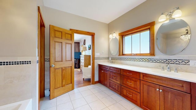 bathroom featuring tile patterned flooring, vanity, and tile walls