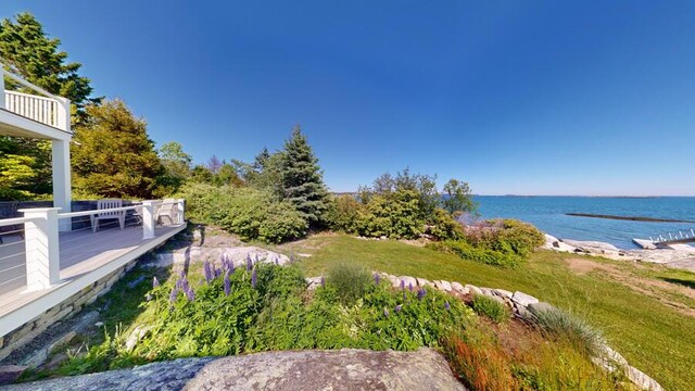 exterior space featuring a deck with water view