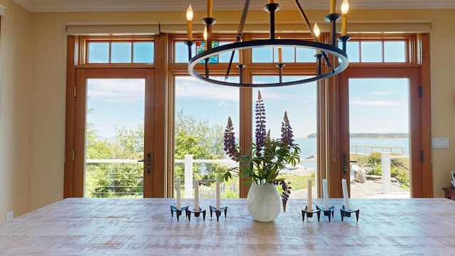 entryway featuring a water view and an inviting chandelier