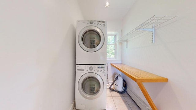 washroom with light tile patterned floors and stacked washer and clothes dryer