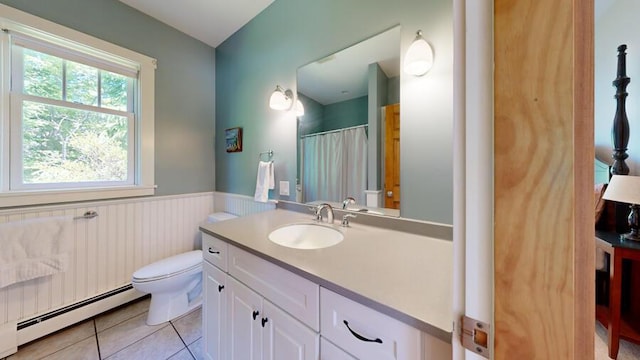 bathroom featuring tile patterned floors, vanity, toilet, and a baseboard heating unit