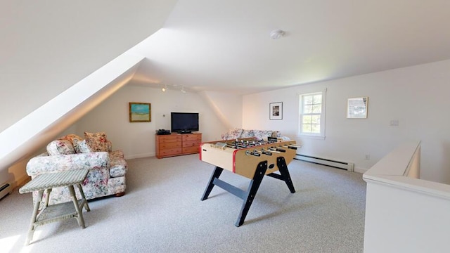 game room with vaulted ceiling, light colored carpet, and a baseboard heating unit