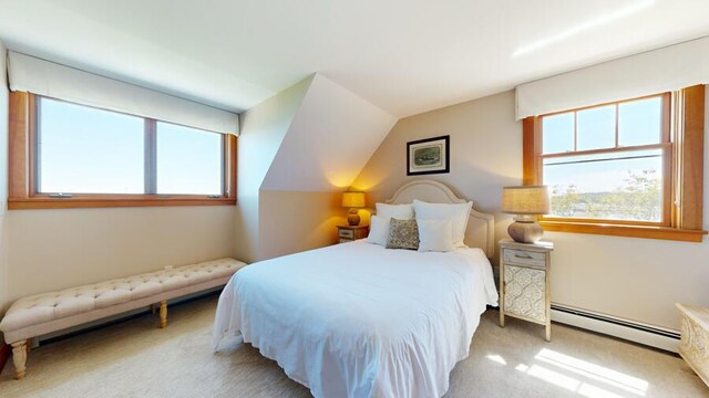 bedroom with carpet, a baseboard radiator, and lofted ceiling