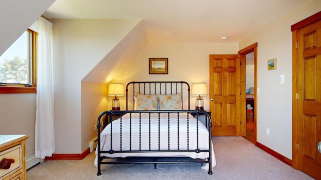 bedroom featuring light carpet and a baseboard heating unit