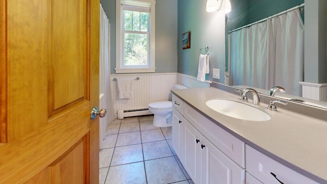 bathroom featuring tile patterned floors, vanity, toilet, and a baseboard heating unit