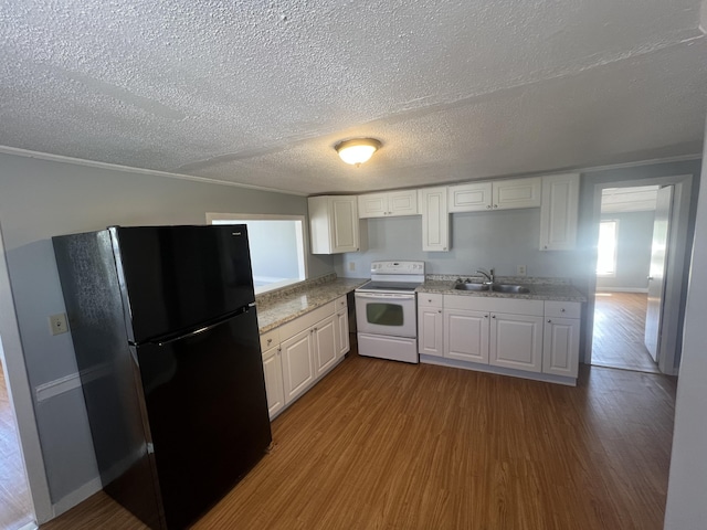 1 Bridge St, Berwick, ME 03901 - kitchen with white range with electric cooktop, freestanding refrigerator, a sink, dark wood finished floors, and a textured ceiling