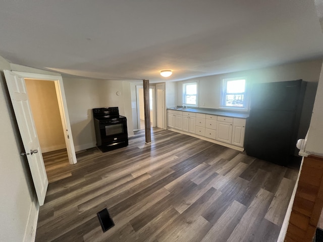 1 Bridge St, Berwick, ME 03901 - below grade area with freestanding refrigerator, dark wood-style flooring, baseboards, and a sink