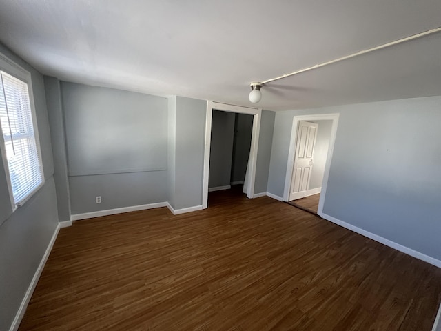 1 Bridge St, Berwick, ME 03901 - unfurnished bedroom featuring dark wood-type flooring, baseboards, and a closet