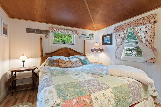 bedroom featuring vaulted ceiling, wooden ceiling, and wood finished floors