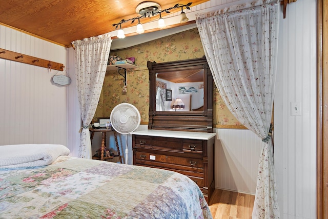 bedroom with wood ceiling and light hardwood / wood-style floors