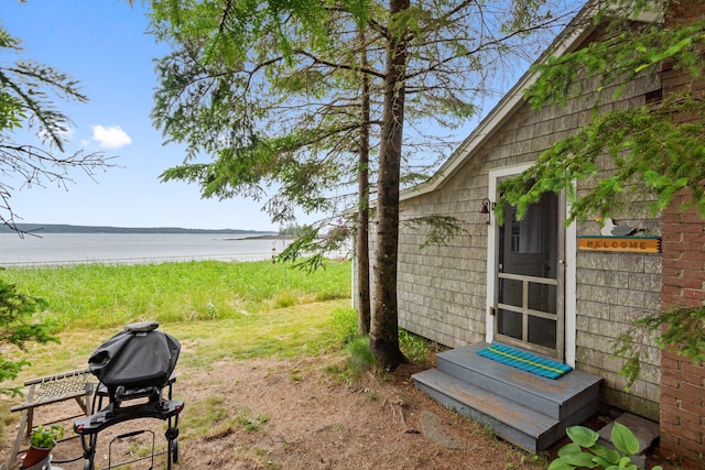 view of yard featuring entry steps and a water view