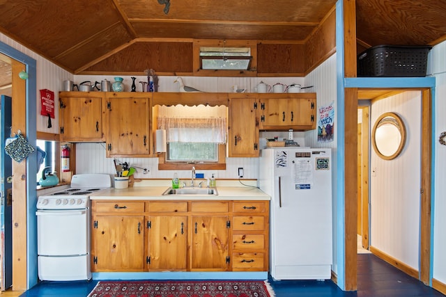 kitchen with lofted ceiling, light countertops, brown cabinetry, a sink, and white appliances