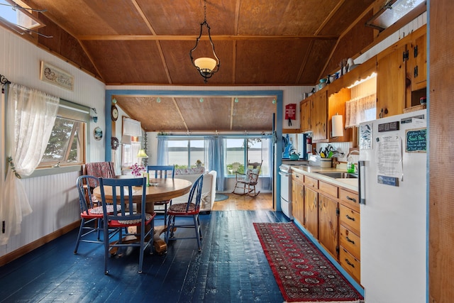 dining area with lofted ceiling with skylight, wooden ceiling, dark hardwood / wood-style flooring, and sink