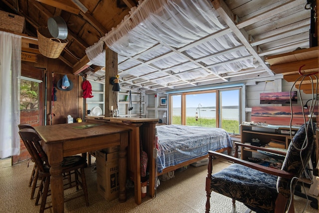 bedroom featuring wooden walls