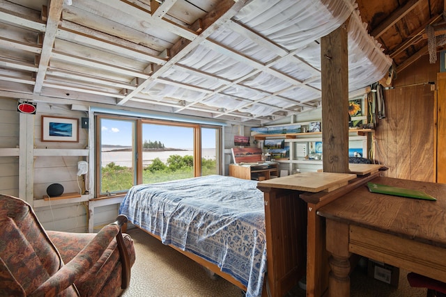 bedroom featuring wood walls