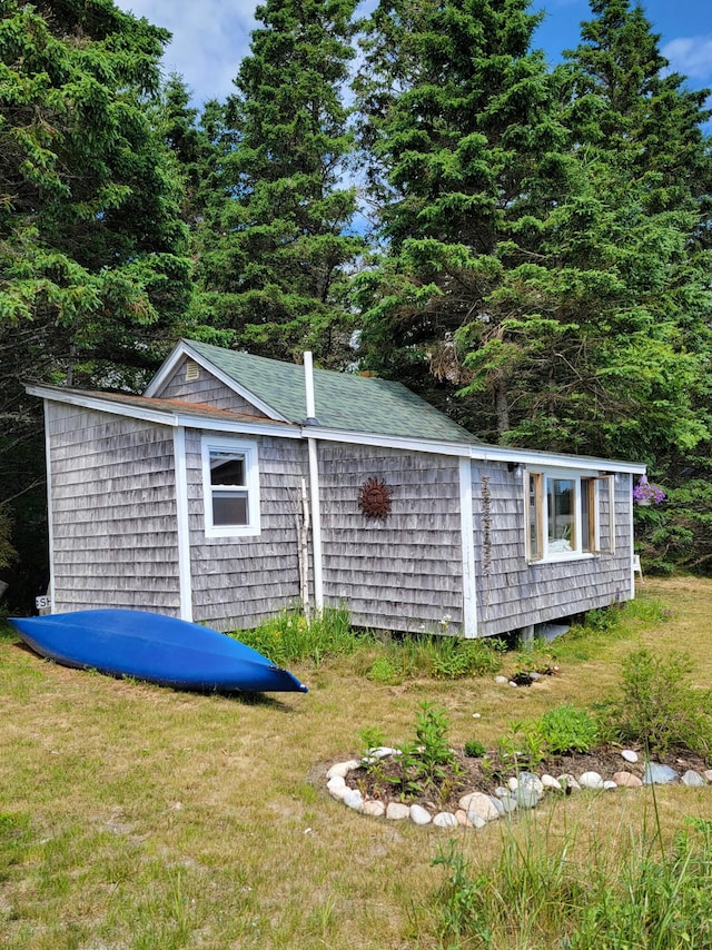 view of outbuilding with a yard