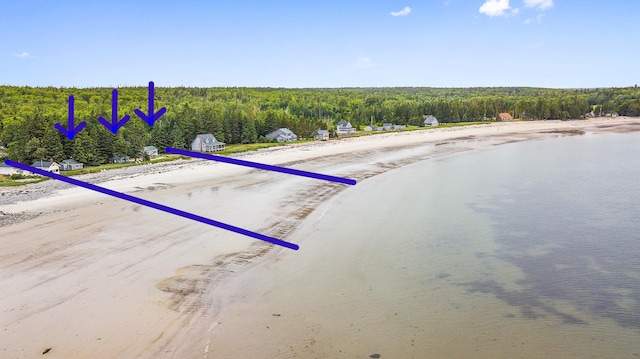 birds eye view of property featuring a wooded view