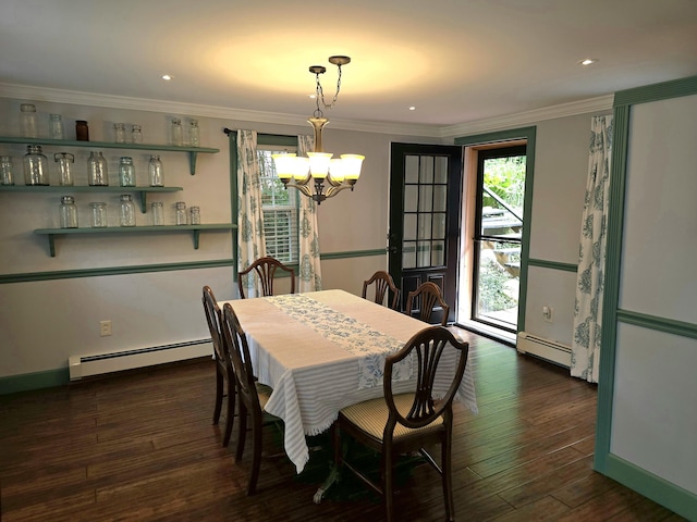 dining area featuring a chandelier, crown molding, dark wood-type flooring, and a baseboard heating unit