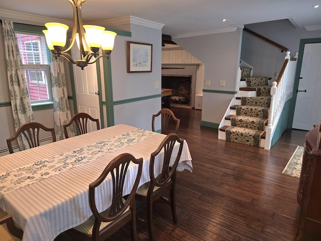 dining room featuring a chandelier, crown molding, and dark wood-type flooring